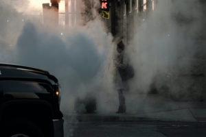 femme accablée par la pollution marchant sur un trottoir
