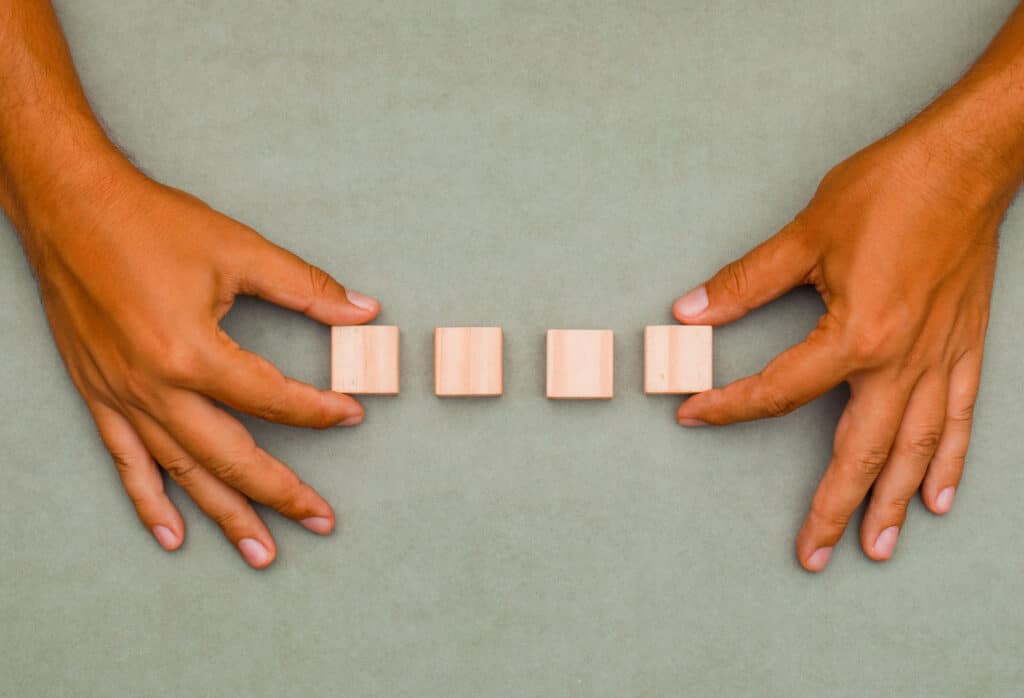 man putting wooden cubes order