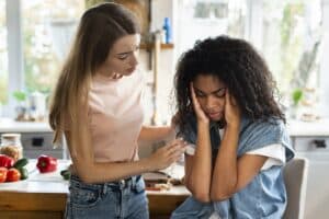 woman consoling her friend kitchen