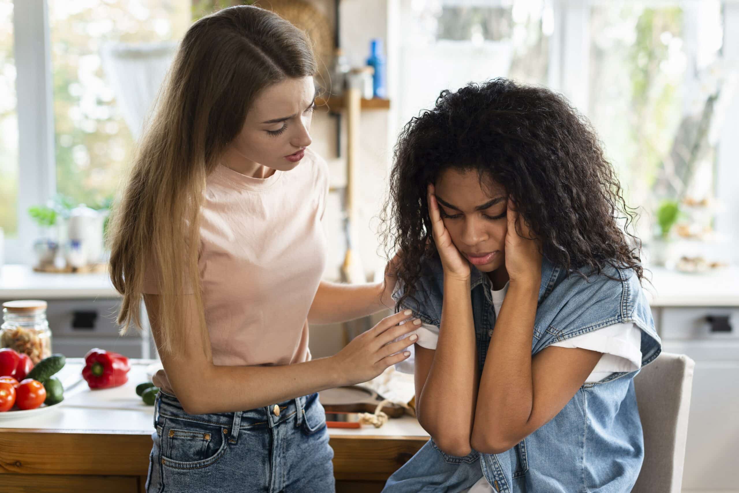 woman consoling her friend kitchen scaled